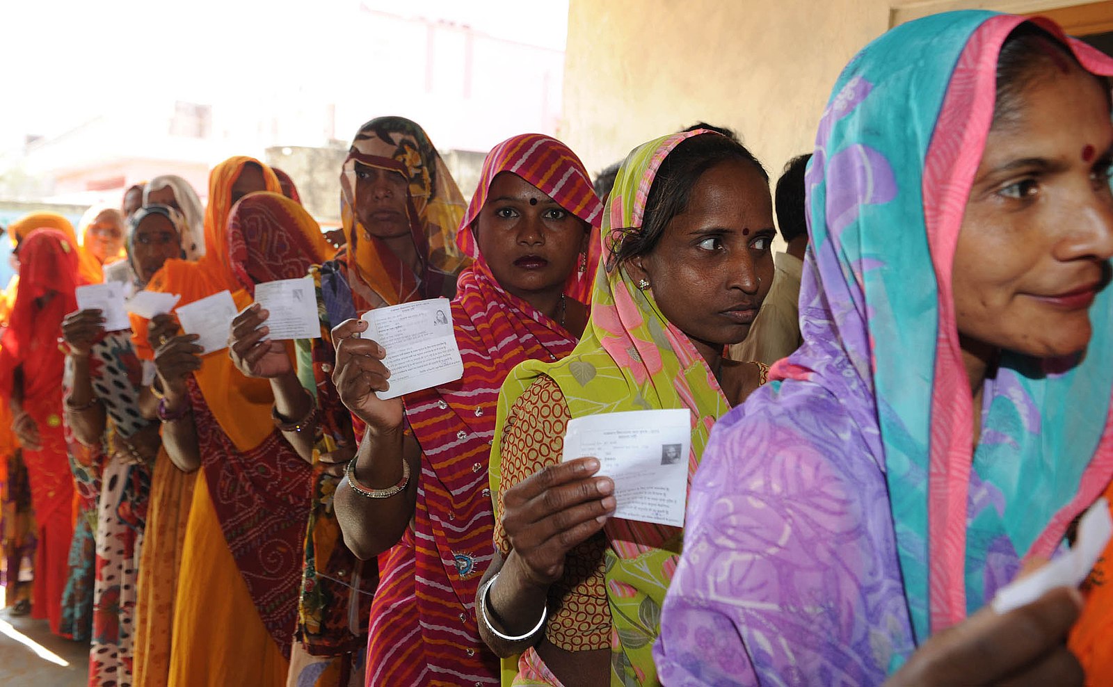 Female voters standing in a queue and waiting for their turn to cast vote at the polling booth of Bassi, during the Rajasthan Assembly Election, in Jaipur on December 01, 2013.